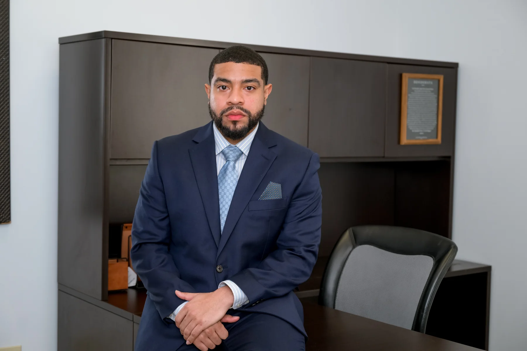 Anthony Morris seated in his office in a navy suit